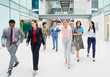 © Robert Daly/Caia Image - Business people walking in modern office atrium lobby