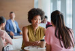 © Robert Daly/Caia Image - Smiling businesswomen enjoying coffee break