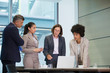 © Robert Daly/Caia Image - Business people working at laptop in conference room meeting