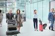 © Robert Daly/Caia Image - Business people with luggage in airport