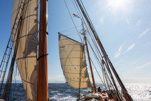 Wooden Sailboat Masts And Sails Under Sunny Blue Sky Atlantic Ocean