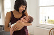 © Sam Edwards/Caia Image - Happy mother holding newborn baby son