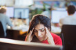 © Tom Merton/Caia Image - Stressed businesswoman with head in hands at computer in office