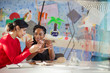 © Tom Merton/Caia Image - Female engineers examining prototype in creative conference room