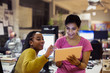 © Tom Merton/Caia Image - Businesswomen using digital tablet in office