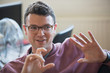 © Tom Merton/Caia Image - Smiling businessman gesturing, explaining
