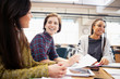 © Sam Edwards/Caia Image - Smiling businesswomen talking in meeting