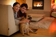 © Tom Merton/Caia Image - Portrait happy couple with dog in living room