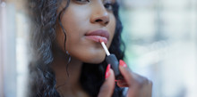 Close Up Beautiful Young Woman Applying Lip Gloss