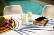 © Tom Merton/Caia Image - Cucumber water and book on sunny summer poolside table