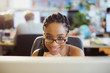 © Tom Merton/Caia Image - Portrait confident businesswoman working at computer in office