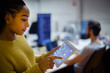 © Tom Merton/Caia Image - Businesswoman using digital tablet in office
