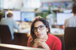 © Tom Merton/Caia Image - Portrait serious, thoughtful businesswoman working in office