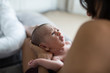 © Sam Edwards/Caia Image - Mother holding cute fussy newborn baby boy