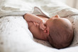 © Sam Edwards/Caia Image - Close up newborn baby boy laying in bassinet