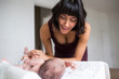 © Sam Edwards/Caia Image - Happy mother watching newborn baby son