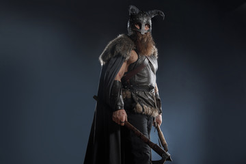 Wall Mural - Warrior Viking in full arms with axe and shield on dark background