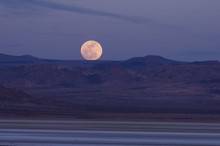 Full Moon Rising In The Mojave Desert In California.