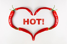 Red Chili Pepper Heart On White Background And Word HOT. Loving Hot Spicy Food Or Valentine's Day Concept. Flat Lay, Top View