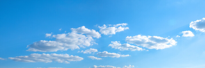 Wall Mural - Beautiful blue sky with white clouds and sun, sunlight background