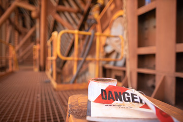 Wall Mural - red and white exclusion dropped zone danger tape tags placing top of working at height permit book a