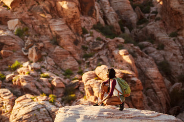 Wall Mural - athletic african american woman backpacker on top of tall cliff at red rock canyon nevada