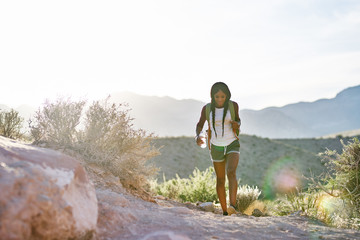 Wall Mural - woman hiking at Red Rock Canyon during sunset with backpack