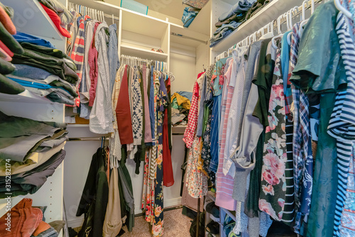 Cuadros en Lienzo Clothing hanging up in a walk-in closet