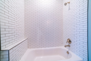 Clean white tiled shower combination tub bright interior