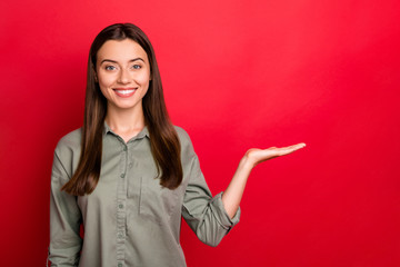 Poster - Portrait of her she nice-looking attractive confident cheerful straight-haired girl holding invisible object on palm gift present surprise isolated over bright vivid shine vibrant red color background