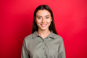 Wall Mural - Close-up portrait of her she nice-looking attractive lovely lovable pretty cheerful cheery straight-haired girl wearing khaki shirt isolated over bright vivid shine vibrant red color background