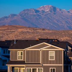 Wall Mural - Square frame Brown urban house with mountain backdrop day light