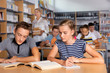 © JackF - Schoolchildren preparing for lesson in school library, reading and writing