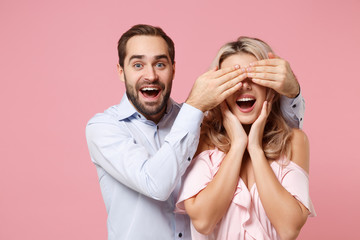 Wall Mural - Excited young couple two guy girl in party outfit celebrating posing isolated on pastel pink background. People lifestyle Valentine's Day Women's Day birthday holiday concept. Covering eyes with hand.