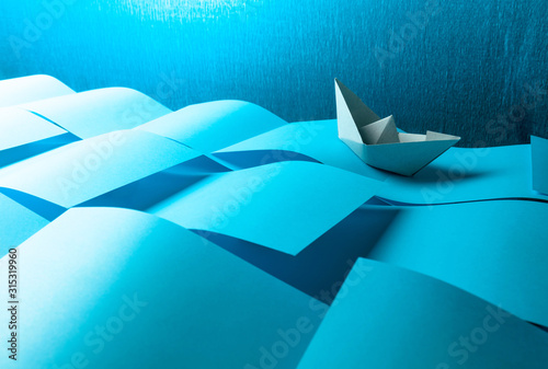Fotografía Paper ship in the paper sea. Concept of the theme of bureaucracy.