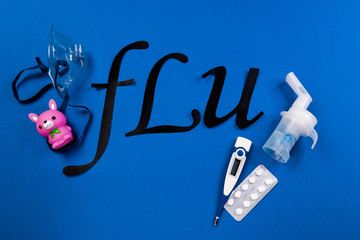 tube mask nebulizer and tubular transparent cable, thermometer, tablets, and the word flu on a blue background, children's colds