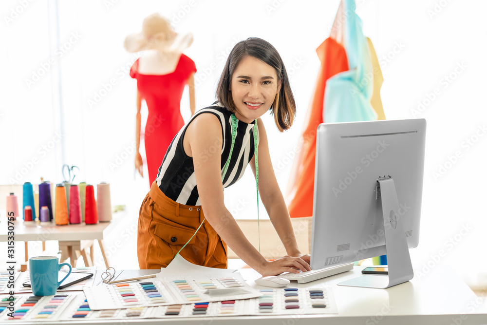 Portrait Young Asian designer woman working with computer and multicolor chart at workplace, small business startup, Business owner entrepreneur, modern freelance job lifestyle concept.asean people