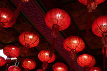 Many Illuminated Red Chinese Lanterns With Some Chinese Characters On It In Temple - Used Across Countries In Asia For Celebrating Chinese New Year Tradition