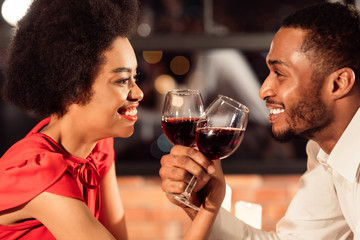 Smiling Couple Drinking Wine During Romantic Valentine Date In Restaurant