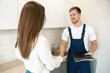 © studioprodakshn - young man plumber and brunette woman client shaking hands after successful work on water tap installation professional repair service