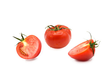 ripe fresh organic tomato and two halves of a tomato in the drops of dew isolated on a white background