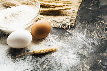 eggs and flour on wooden table. Baking background