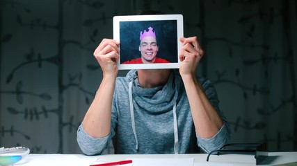 Poster - A man holds a tablet in his hands