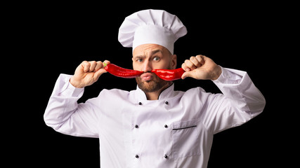 Chef Man Holding Red Peppers Like Moustaches, Black Background, Panorama