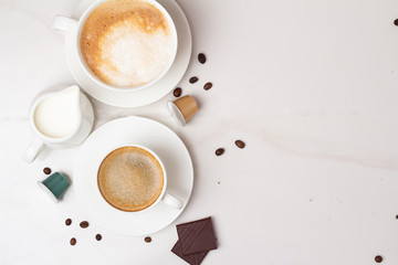 cup of coffee with cream on wooden background