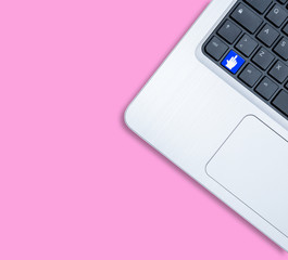 Modern notebook computer with fuck off key concept on pink background