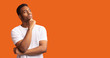 © Prostock-studio - Pensive black man profile portrait on orange background