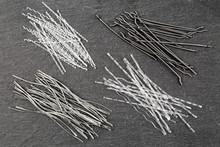 Close Up, Top Down View Of A Set Of Four Different Types Concrete Reinforcement Macro Fibers - Hooked End Steel, White Polypropylene Sinusoidal And Crimped, And Grey Colored Twisted