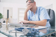 © Monika Wisniewska - Overworked doctor in his office