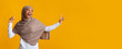 © Prostock-studio - Carefree afro muslim girl in hijab looking aside at copy space